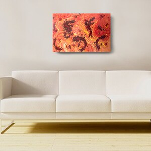 May include: Abstract painting with swirling red, orange, and yellow colors. The painting has a textured surface with black accents.