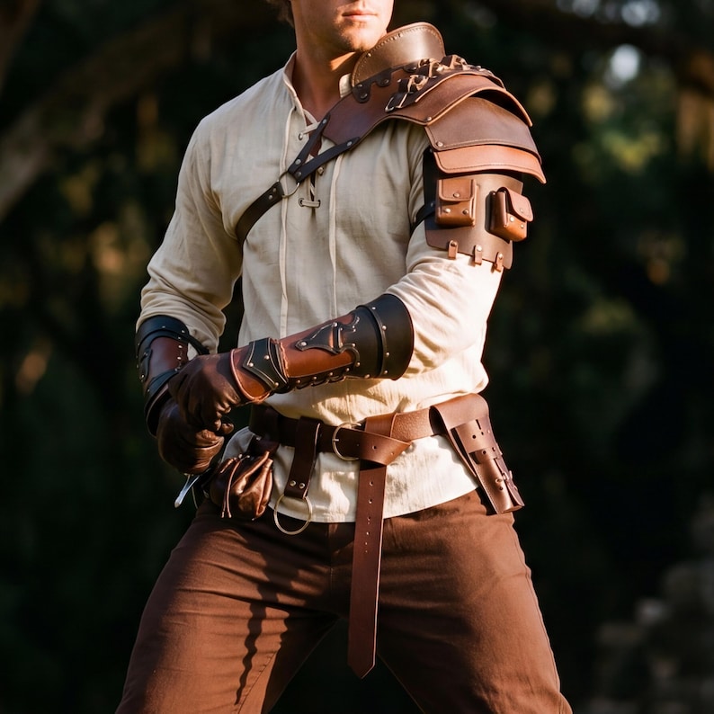 May include: Brown leather shoulder armor with small pouches and metal accents. The armor is paired with matching brown leather arm guards, gloves, and a belt with a pouch. The outfit is completed with a cream-colored shirt and brown pants.
