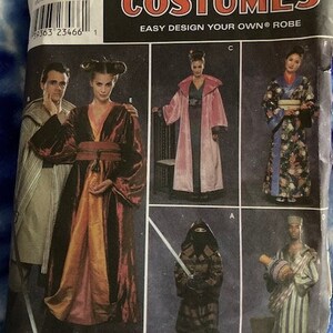 May include: Simplicity Costumes pattern featuring various robe designs. The pattern includes images of people in different costumes, including a pink robe, a kimono, and a warrior outfit. The text "EASY DESIGN YOUR OWN ROBE" is visible.
