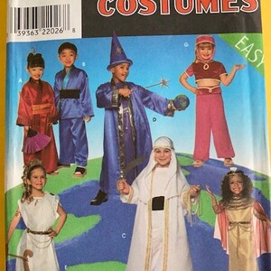 May include: A Simplicity Costumes sewing pattern for children's costumes. The pattern includes five different costumes: a wizard, a genie, a princess, a shepherd, and a Roman. The pattern is labeled "Easy" and includes sizes A, S, M, and L.