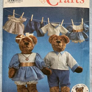 May include: A Simplicity Crafts sewing pattern for making teddy bears. The pattern is for one size and includes instructions for making both a boy and girl bear. The pattern also includes instructions for making clothes for the bears, including a dress, shirt, pants, and shorts.