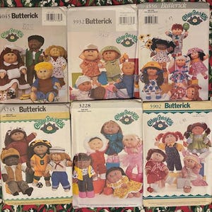 May include: Six Butterick Cabbage Patch Kids sewing pattern envelopes featuring illustrations of dolls in various outfits. The patterns are numbered 4045, 3932, 4556, 3745, 3228, and 5902, each displaying multiple doll clothing designs.