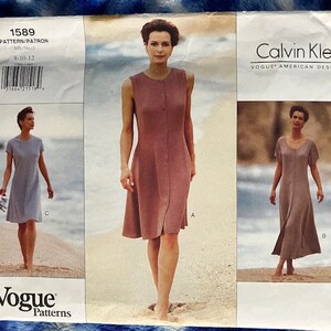 May include: A vintage Vogue Patterns sewing pattern featuring three dress designs by Calvin Klein. The pattern includes a sleeveless dress, a short-sleeved dress, and a dress with a V-neck and short sleeves. The pattern size is 8-10-12.