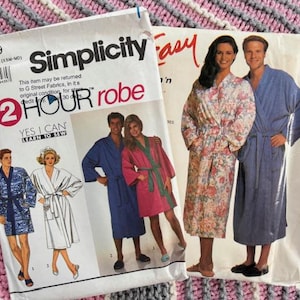 May include: Two vintage sewing patterns for robes. One pattern is labeled "Simplicity 2 HOUR robe" with illustrations of the finished product. The other pattern is labeled "Easy" with a photo of a couple wearing robes.