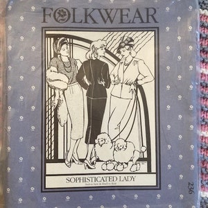 May include: A vintage sewing pattern from Folkwear, pattern number 236, titled "Sophisticated Lady". The pattern features three women wearing dresses and hats, with two dogs in the foreground. The pattern is printed on a blue background with a white floral pattern.