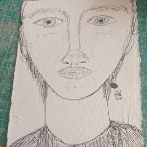May include: A monochrome sketch of a face, rendered on textured paper. The artwork showcases detailed eyes, a nose, and a mouth. The drawing is signed with Korean characters and the year 2023.
