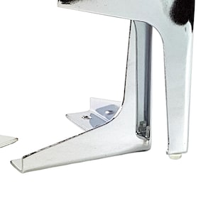 May include: A set of chrome-finished furniture legs. Each leg has a right-angle design with a flat top and a vertical support. The legs are designed for mounting on a flat surface and have a small, clear foot.