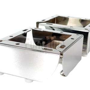 May include: Two shiny, chrome-finished furniture legs. Each leg is a rectangular box shape with a hollow interior and small white feet. The legs have pre-drilled holes for easy attachment to furniture.