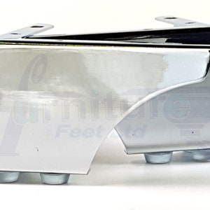 May include: Chrome furniture leg with a curved design and four rubber feet. The leg is designed to be attached to a piece of furniture.