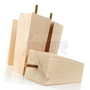 May include: Four unfinished wooden furniture legs with metal screws. The legs are rectangular in shape and are stacked on top of each other.