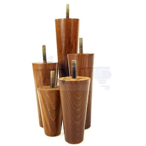 May include: Set of five wooden furniture legs in various sizes. The legs are tapered and have a dark brown finish. They are made of solid wood and have a threaded metal insert for attaching to furniture.
