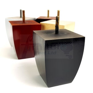 May include: Four wooden furniture legs in various colors: black, red, silver, and beige. Each leg has a square top and a curved, tapered base, with a threaded bolt protruding from the top. The legs are designed for furniture.
