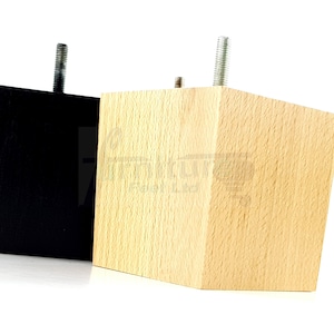 May include: Two wooden furniture legs with a square shape and a threaded metal screw on top. One leg is black and the other is natural wood.