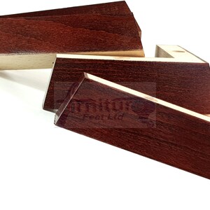May include: Set of five dark brown wooden furniture legs with a light wood trim. The legs are shaped like a right angle and are designed to be attached to furniture.