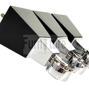 May include: Three black and silver furniture legs with a square base and a rounded top. The legs are made of metal and have a polished finish.