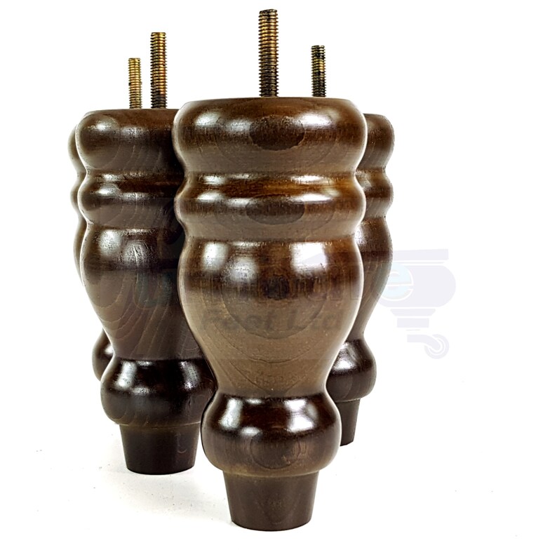 May include: Four dark brown wooden furniture legs with a turned design and a metal screw at the top. The legs are arranged in a row, with the screw of each leg facing forward.