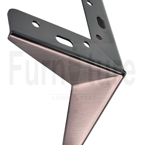 May include: A bronze-colored metal furniture leg with a V-shape design. The leg has a brushed metal finish and features pre-drilled holes for easy installation. The words "Furniture Legs & Feet" are printed on the leg.