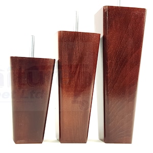 May include: Three wooden furniture legs in different sizes. The legs are a dark reddish-brown color and have a tapered shape. Each leg has a metal screw for attaching to furniture.