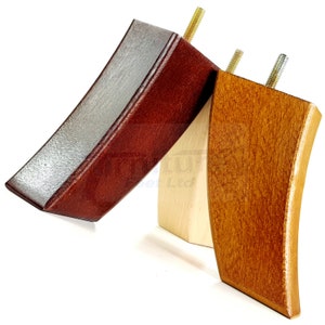 May include: Three wooden furniture legs in different colours: dark red, natural wood, and light brown. Each leg has a curved design and a metal threaded insert. The legs are angled and appear to be new.