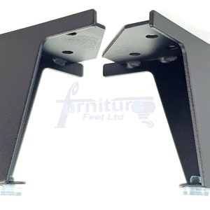 May include: Two brown metal furniture legs with a triangular shape and a flat top. Each leg has a round, silver base.