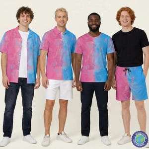 May include: A collection of apparel featuring a pink and blue watercolour-style pattern. The set includes a short-sleeved button-down shirt, a polo shirt, a crew-neck t-shirt, and shorts, all displaying a split-colour design in pink and blue.