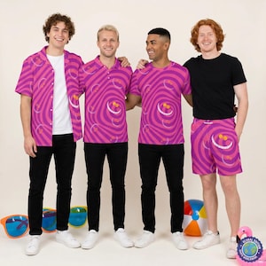 May include: A collection of clothing featuring a vibrant pink and purple swirling pattern with a repeating Cheshire Cat grin motif. The set includes a short-sleeved button-down shirt, a polo shirt, a crew-neck t-shirt, and a pair of elastic-waist shorts.