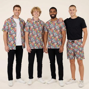 May include: A collection of clothing featuring a colourful cartoon character print. The set includes a short-sleeved button-down shirt, a polo shirt, a crew-neck t-shirt, and shorts, all showcasing a vibrant, multi-coloured graphic pattern.