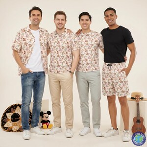 May include: Four individuals wearing clothing featuring a repeating Disney character pattern. The outfits include a short-sleeved button-down shirt, a polo shirt, a crew-neck t-shirt, and shorts, paired with blue jeans, khaki trousers, and light trousers.