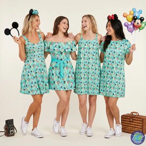 May include: Four sleeveless dresses in a light teal fabric featuring a repeating pattern of Mickey Mouse and tropical foliage. The dresses include a tank-style cut and an off-the-shoulder design with a waist tie, paired with white canvas trainers.