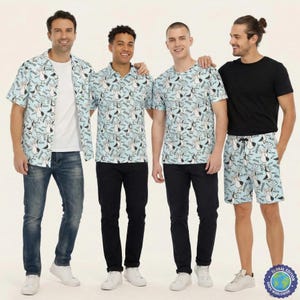 May include: A collection of light blue clothing featuring a repeating pattern of cartoon seagulls and the text MINE. The set includes a short-sleeved button-down shirt, a polo shirt, a crew-neck t-shirt, and a pair of drawstring shorts with pockets.