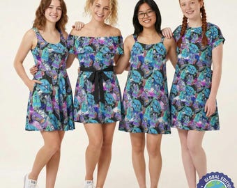 May include: Four dresses featuring a dark, cosmic-inspired print with vibrant blue, purple, and green graphic elements. The dresses include various necklines such as scoop, off-the-shoulder with a ruffle, and cap sleeves, all showcasing a repeating pattern.