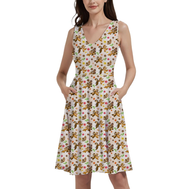 a woman is wearing a dress with flowers on it