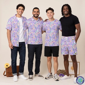 May include: A collection of apparel featuring a light purple fabric with a repeating pattern of colorful castles, flowers, and rainbows. The set includes a short-sleeved button-down shirt, a polo shirt, a t-shirt, and drawstring shorts with white ties.