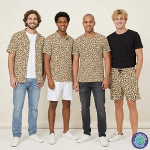 May include: Four outfits featuring a tan and brown leopard print pattern with hidden Mickey Mouse silhouettes. The collection includes a short-sleeve button-down shirt, a polo shirt, a crew-neck t-shirt, and a pair of drawstring shorts.