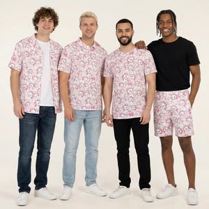 May include: Four individuals wearing clothing with a pink and white repeating cartoon character pattern. The outfits include a short-sleeved button-down shirt, a polo shirt, a crew-neck t-shirt, and shorts, paired with various denim and black trousers.