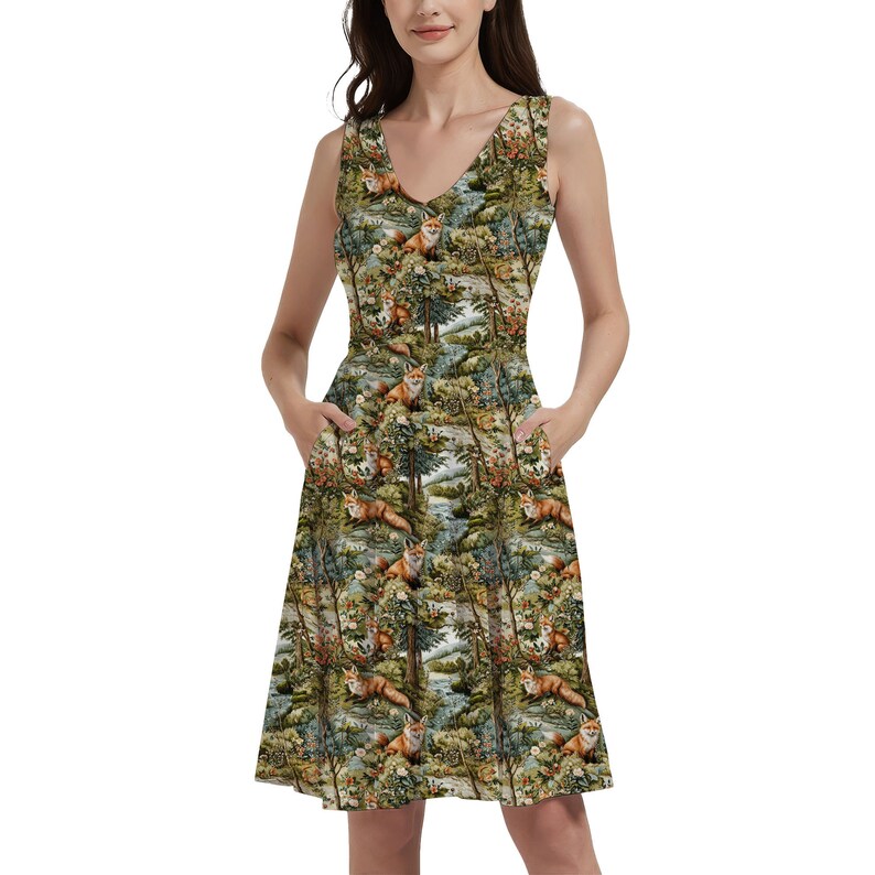 May include: A sleeveless dress with a V-neckline and a forest scene print featuring foxes, trees, and flowers. The dress has pockets on both sides and a flared skirt.