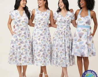 Puede incluir: Cuatro mujeres con vestidos blancos con un estampado repetido de castillos, nubes y coronas en azul, morado y dorado. Los vestidos tienen diferentes estilos, incluyendo mangas con volantes, sin mangas y cuello halter. Los vestidos son hasta la rodilla y se combinan con tacones blancos.