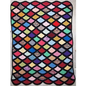 May include: A colorful crocheted blanket with a black border and a scalloped edge. The blanket is made up of a repeating pattern of diamond-shaped squares in various colors, including red, blue, green, yellow, and purple.