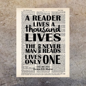 May include: A black and white typography print with the quote "A reader lives a thousand lives, the man who never reads lives only one." The quote is superimposed on a vintage dictionary page.