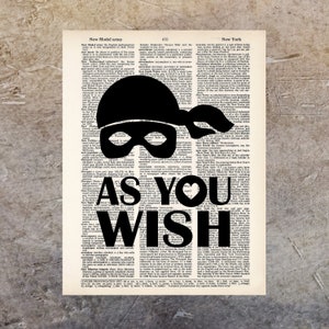 May include: Black and white typography art print with the text "As You Wish" superimposed on a vintage dictionary page. The text is in a bold, stylized font with a heart shape in the "You".