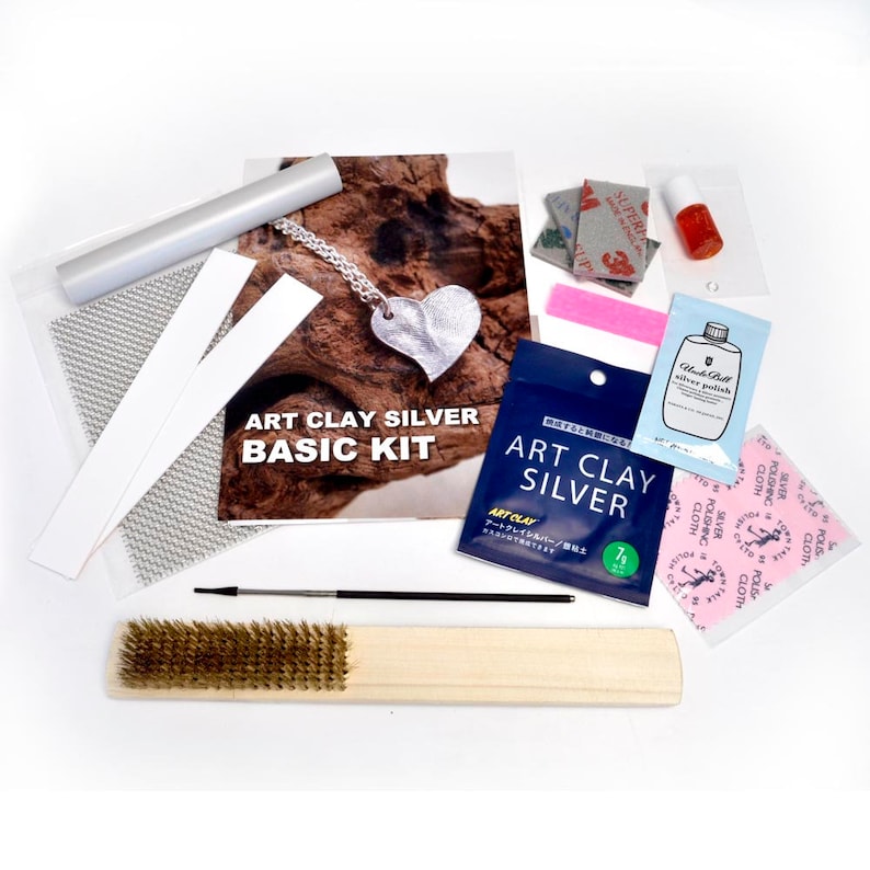 May include: Art clay silver basic kit with tools and supplies. Includes a silver polishing cloth, a silver polish bottle, a small brush, a sanding block, a silver clay packet, and two white strips.