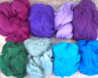 May include: Eight different colors of wool roving, including purple, pink, blue, green, and teal.