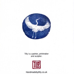 May include: A white crane with wings outstretched is printed in white against a blue circle. The text "Tilly is a painter, printmaker and sculptor." is below the image. The text "TILLY" is in a red square below the text. The text "Handmadebytilly.co.uk" is below the square.