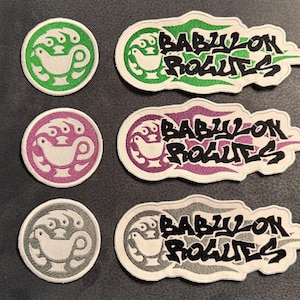 May include: Three sets of embroidered patches, each including a circular emblem featuring a white bird-like icon and a larger, irregular-shaped patch displaying the text "BABYLON ROGUES" in black, available in green, purple, and grey color variations.