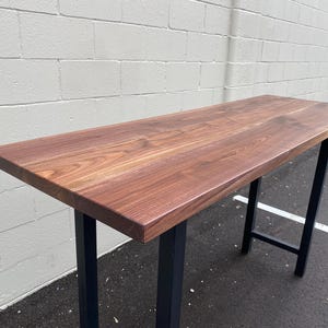 May include: A rustic wooden sign with the text "Welcome to our home" in white lettering. The sign features a distressed finish and a simple, inviting design, perfect for entryway decor.