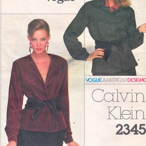 May include: A sewing pattern for a women's blouse by Calvin Klein. The pattern is for a burgundy velvet blouse with a black belt and a long sleeve. The pattern is from Vogue American Designer Collection and is number 2345.