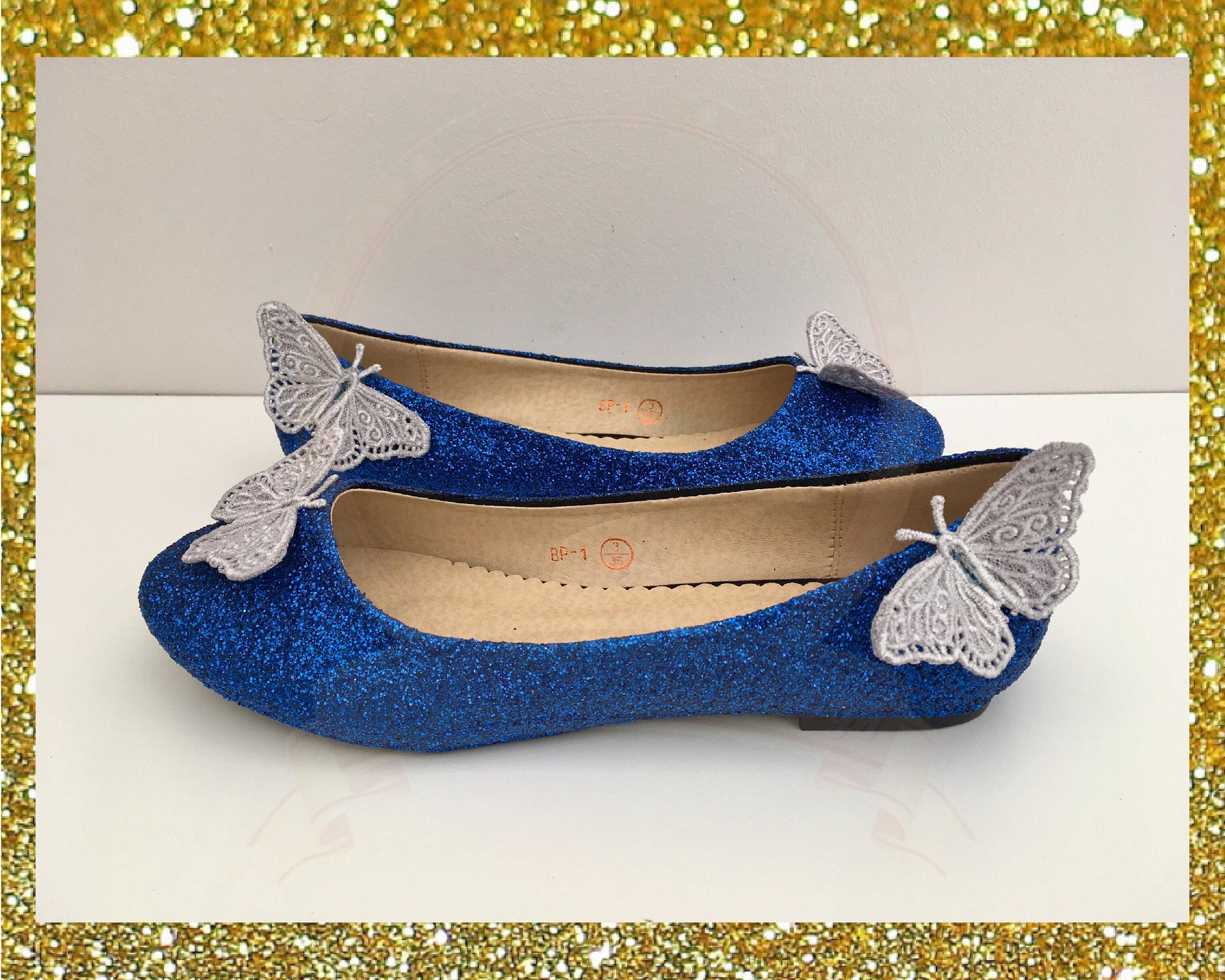 white shoes with blue butterflies
