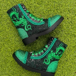 May include: Green glitter combat boots with black lace and a green dragon embroidery.