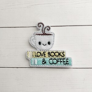 May include: Embroidered patch with a cute cartoon coffee cup with a happy face and steam coming out of the top. The cup is sitting on top of two books that say "I Love Books & Coffee".