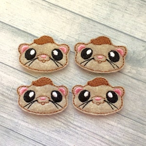 May include: Four brown and beige felt appliques of cartoon ferret faces with black eyes, pink noses, and brown whiskers.